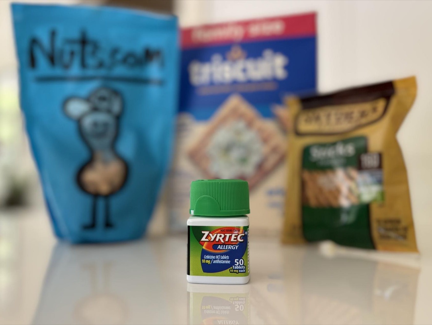 Allergy medication in front of everyday snack foods